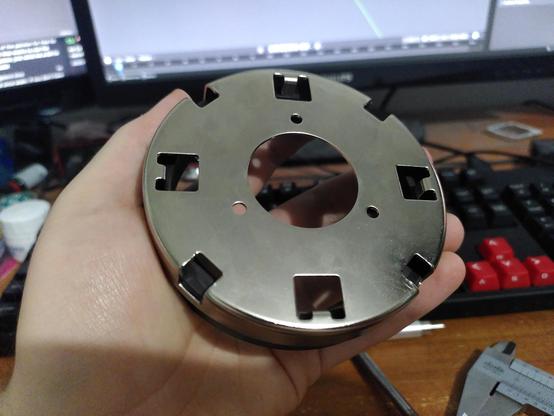the bottom of the magnet, it's got four square holes which hold the magnet in place, four square indentations which align it with the platter, and three screw holes which will keep it connected to the platter. there is also one large hole in the middle